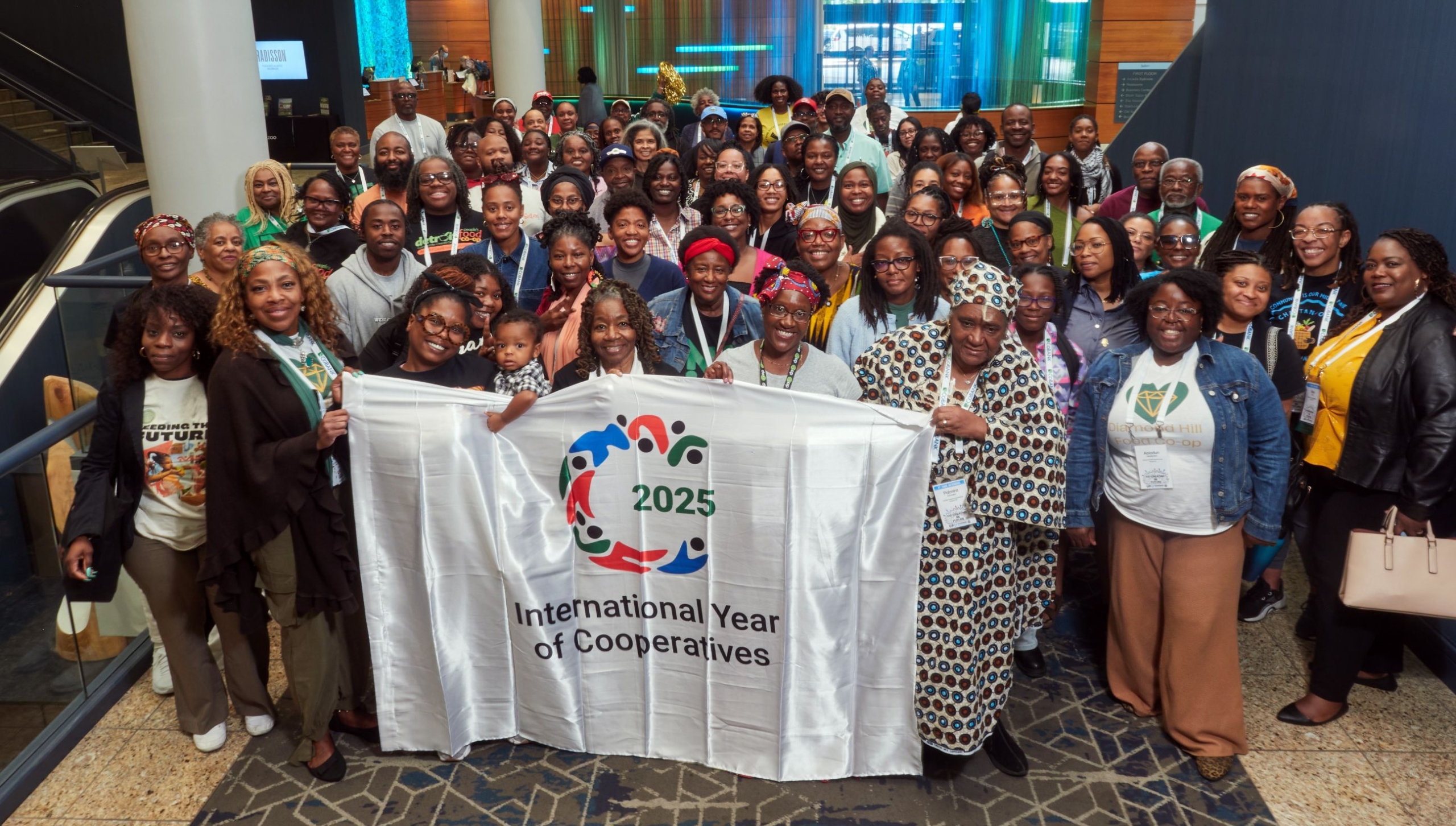 2025 Black Led Day attendees posing with the International Year of Cooperatives banner